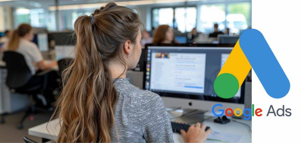 Google Ads audience analytics. Woman analyzing Google Ads campaign performance on a desktop computer in a busy office environment.